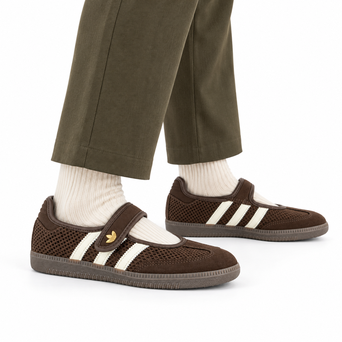 adidas Originals Samba Jane – Brown / Off White / Gold worn with olive tailored trousers and ecru ribbed socks, both shoes facing right
