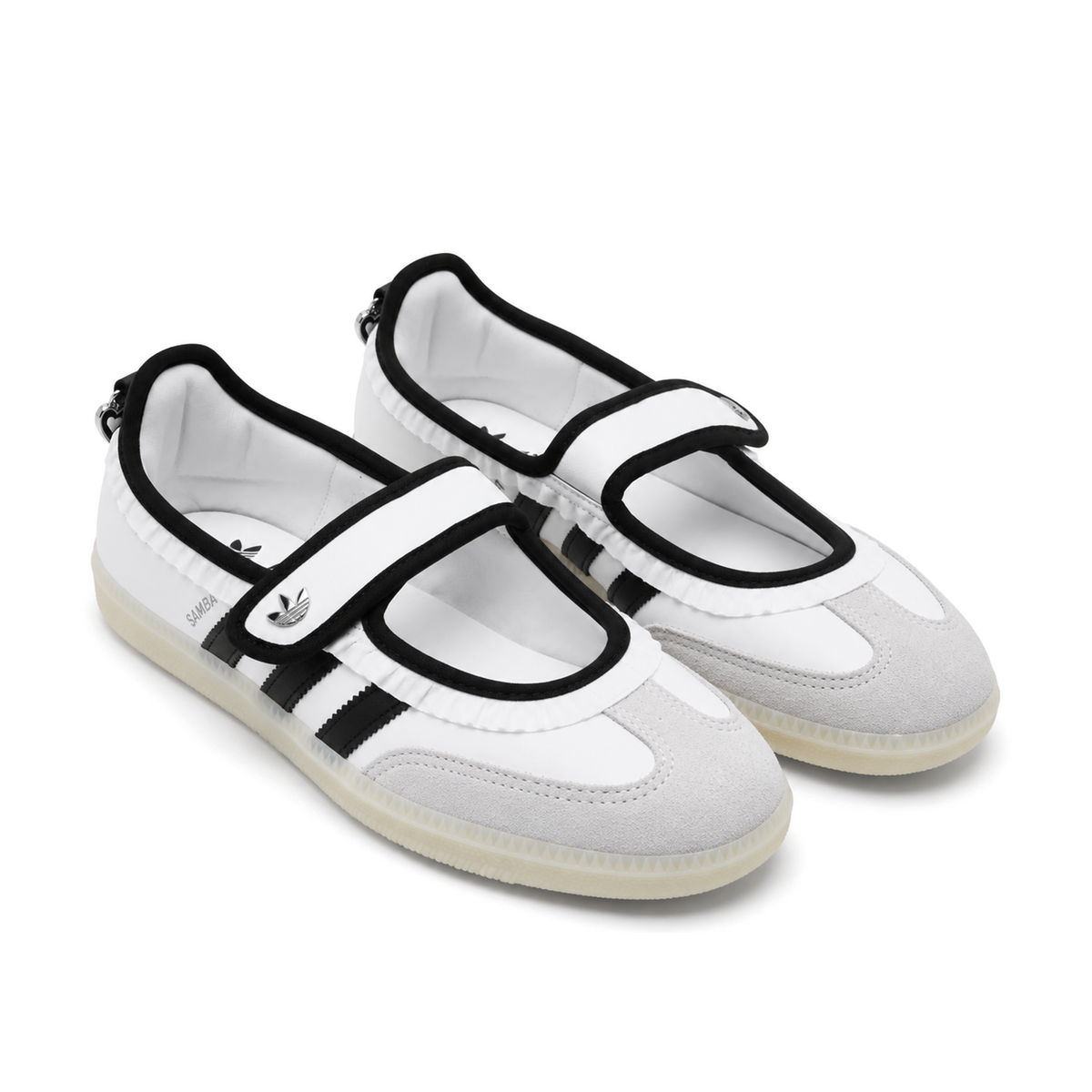 Front three-quarter view of the white and black Samba Jane Ruffle pair, showing black-edged Mary Jane straps and light grey T-toe panels.