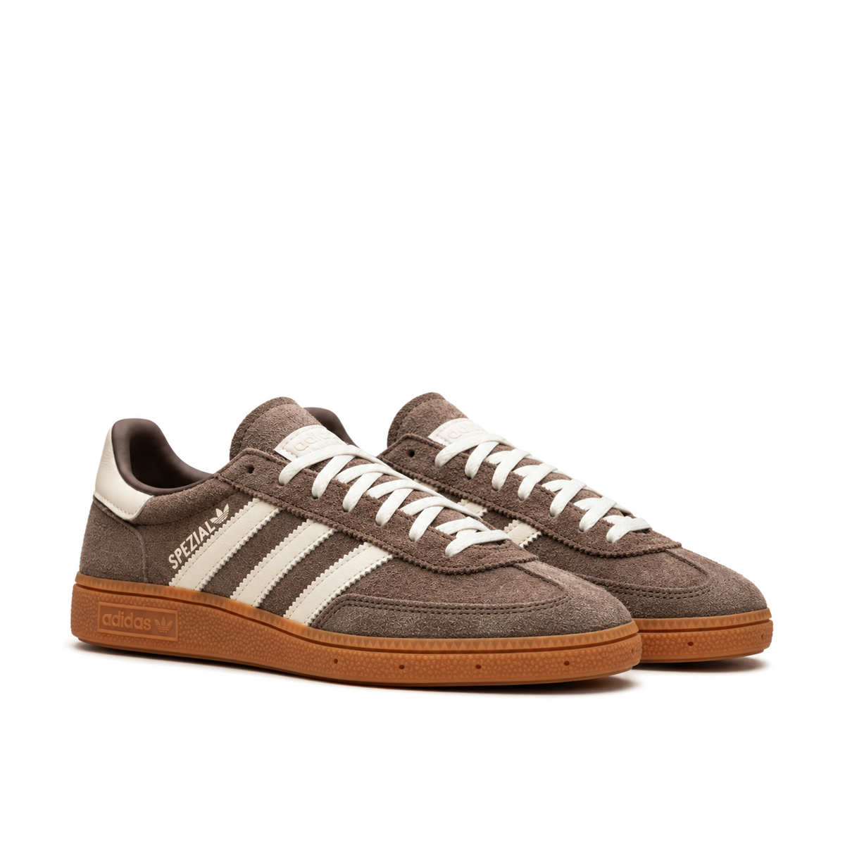 Front three-quarter view of the brown and cream Handball Spezial pair, showing textured toe panels and cream laces.