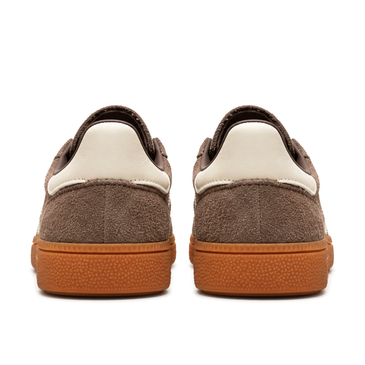 Straight rear view of brown adidas Handball Spezial shoes with plain cream heel tabs and warm gum soles.