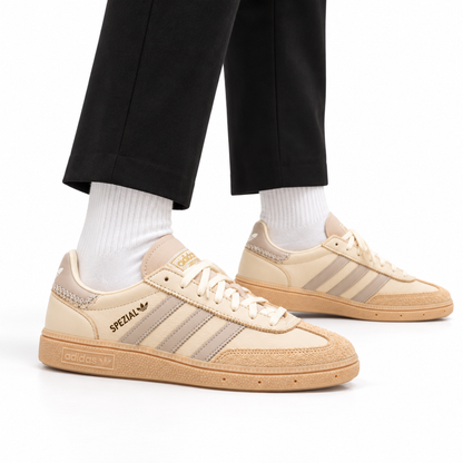 adidas Handball Spezial – Cream White Beige worn with cropped black tailored trousers and white crew socks, both shoes facing right