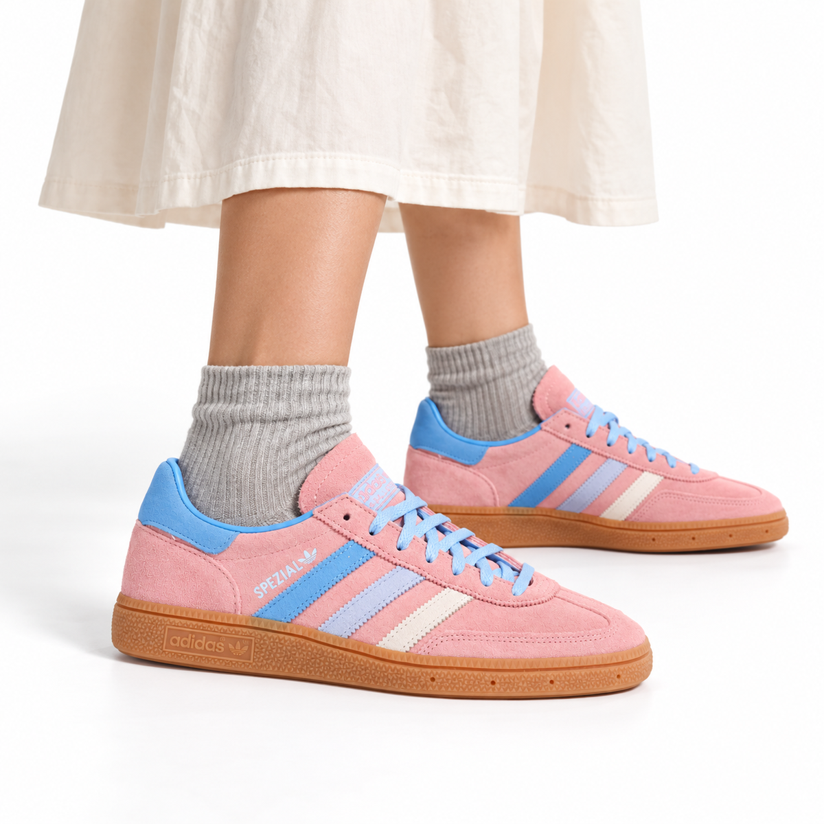 adidas Handball Spezial Women's Sneakers – Semi Pink Spark worn with an ivory midi skirt and soft grey ankle socks, both shoes facing right