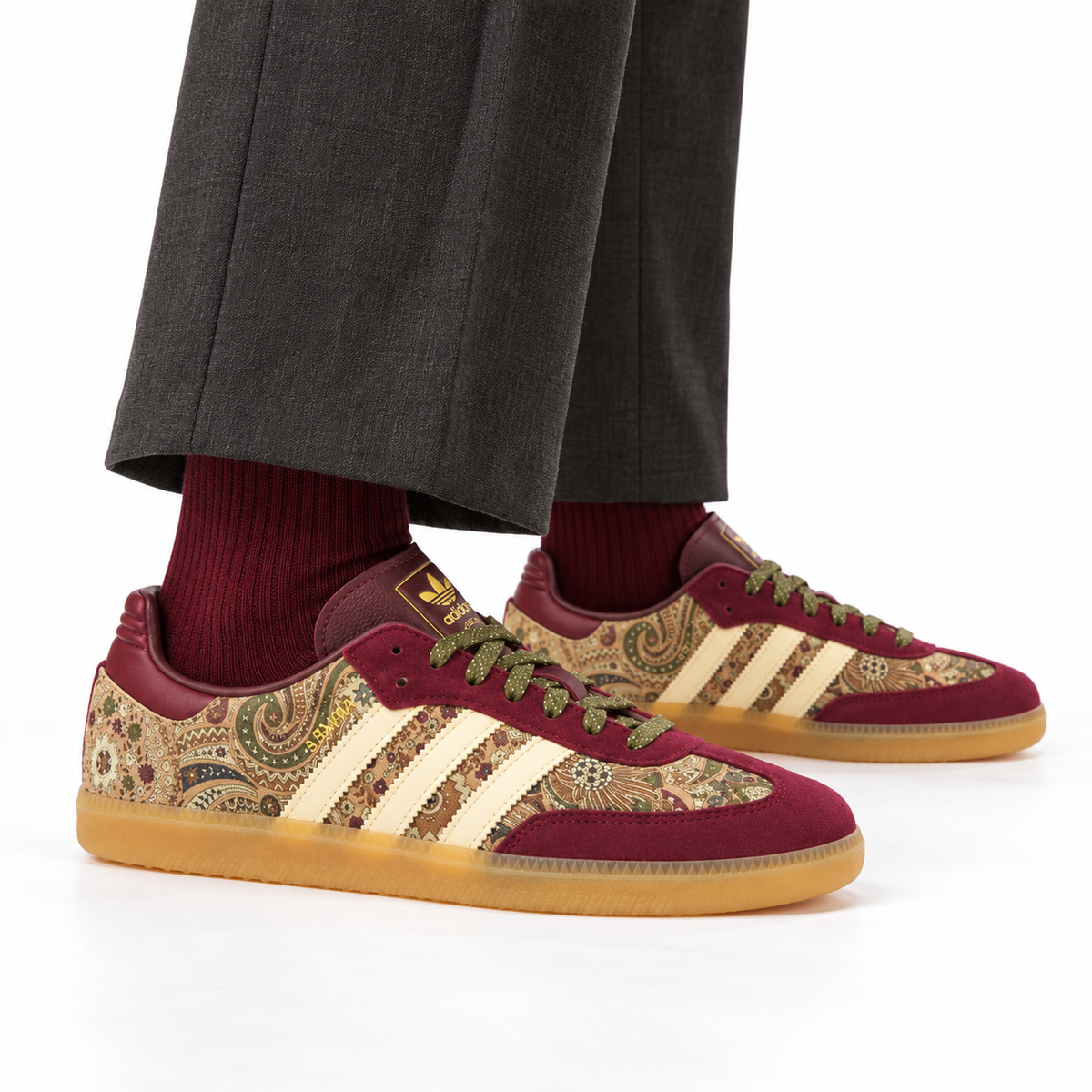 adidas x Liberty London Samba OG – Maroon Paisley worn with charcoal pleated trousers and burgundy ribbed socks, both shoes facing right