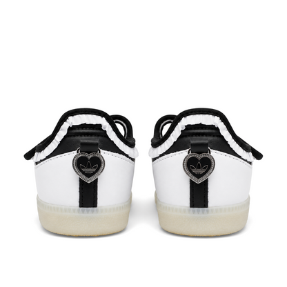 Straight rear view of adidas Samba Jane Ruffle shoes with black-centred silver heart heel charms and gathered white trim.