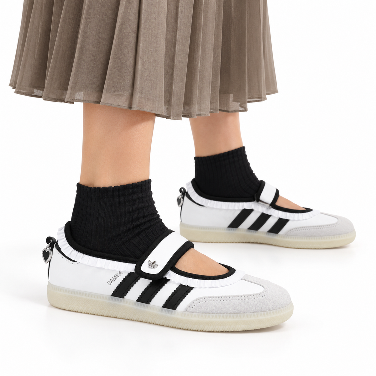 adidas Samba Jane Ruffle Pack – White, Black & Gum (Women’s) worn with a taupe pleated midi skirt and fine black ankle socks, both shoes facing right