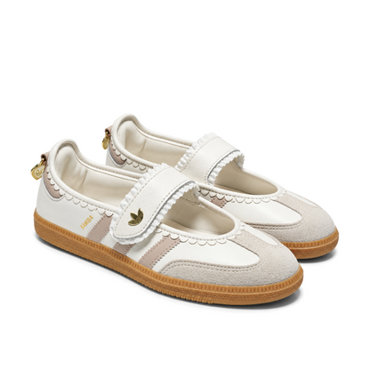Front three-quarter view of the adidas Samba Jane Ruffle pair, showing pale pink Three Stripes, scalloped edging and contrasting T-toe panels.