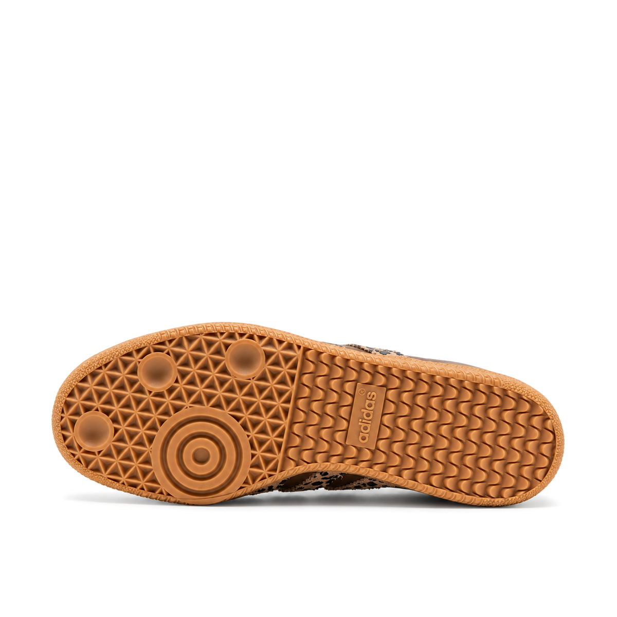 Gum outsole of the adidas Samba OG, showing circular forefoot tread, a wave-patterned heel and embossed adidas lettering.