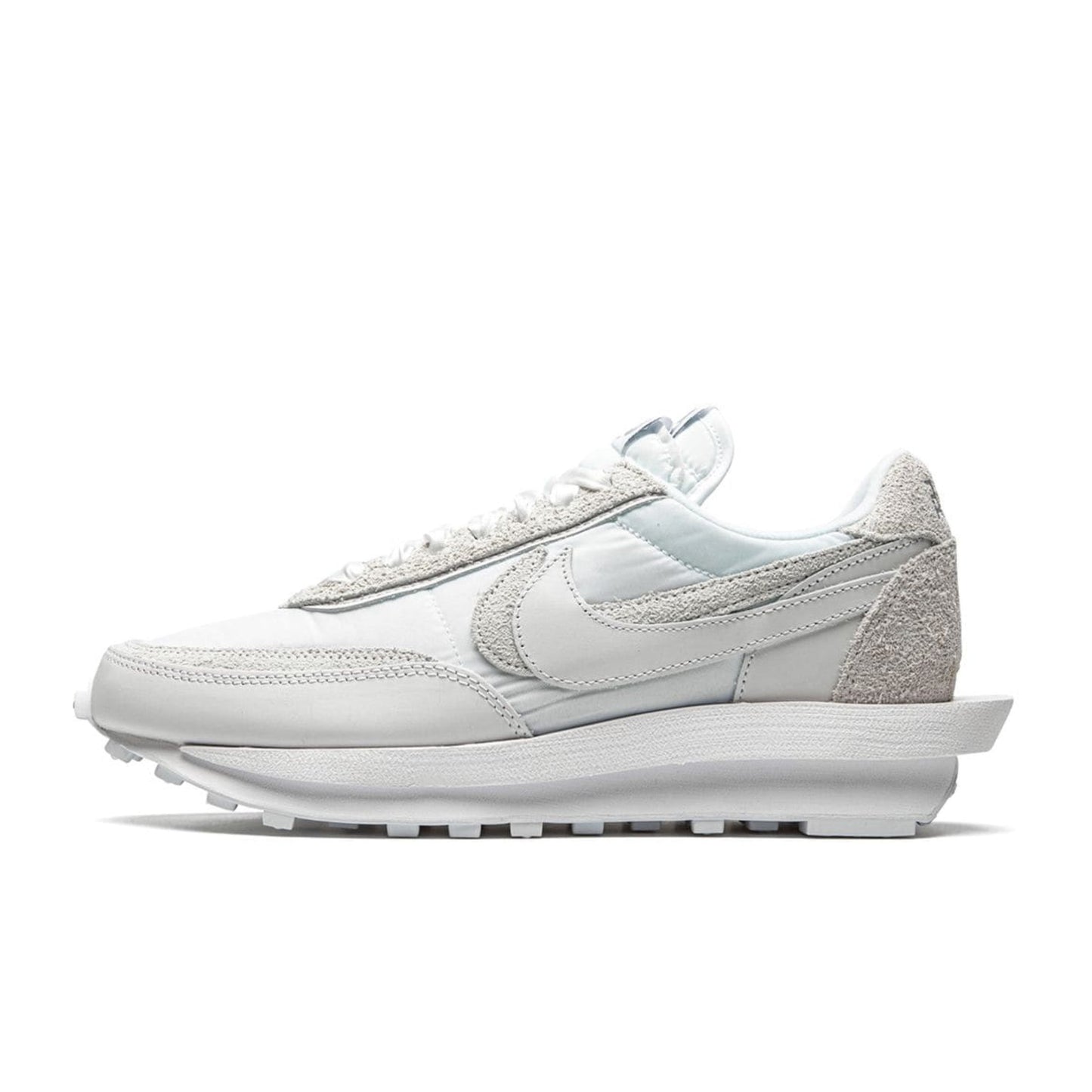 A pair of Nike LD Waffle unisex sneakers in white, featuring a nylon upper with mesh accents, a suede toe box, and a stacked foam midsole.
