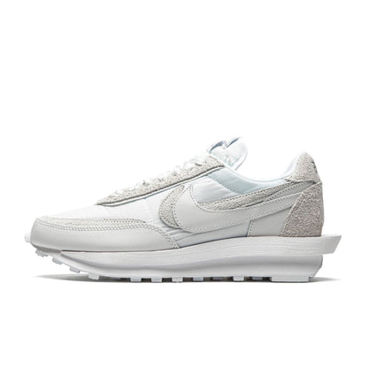 A pair of Nike LD Waffle unisex sneakers in white, featuring a nylon upper with mesh accents, a suede toe box, and a stacked foam midsole.