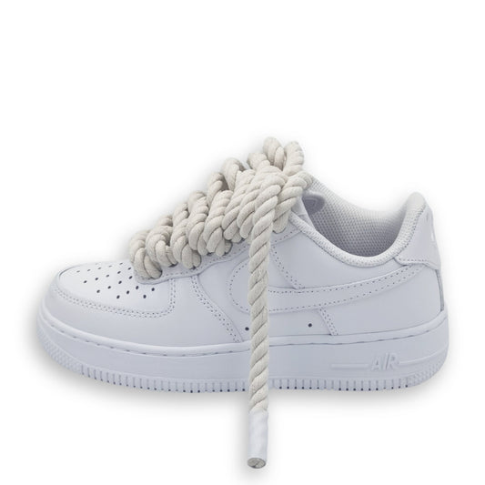A white Nike Air Force 1 shoe with cream rope laces.