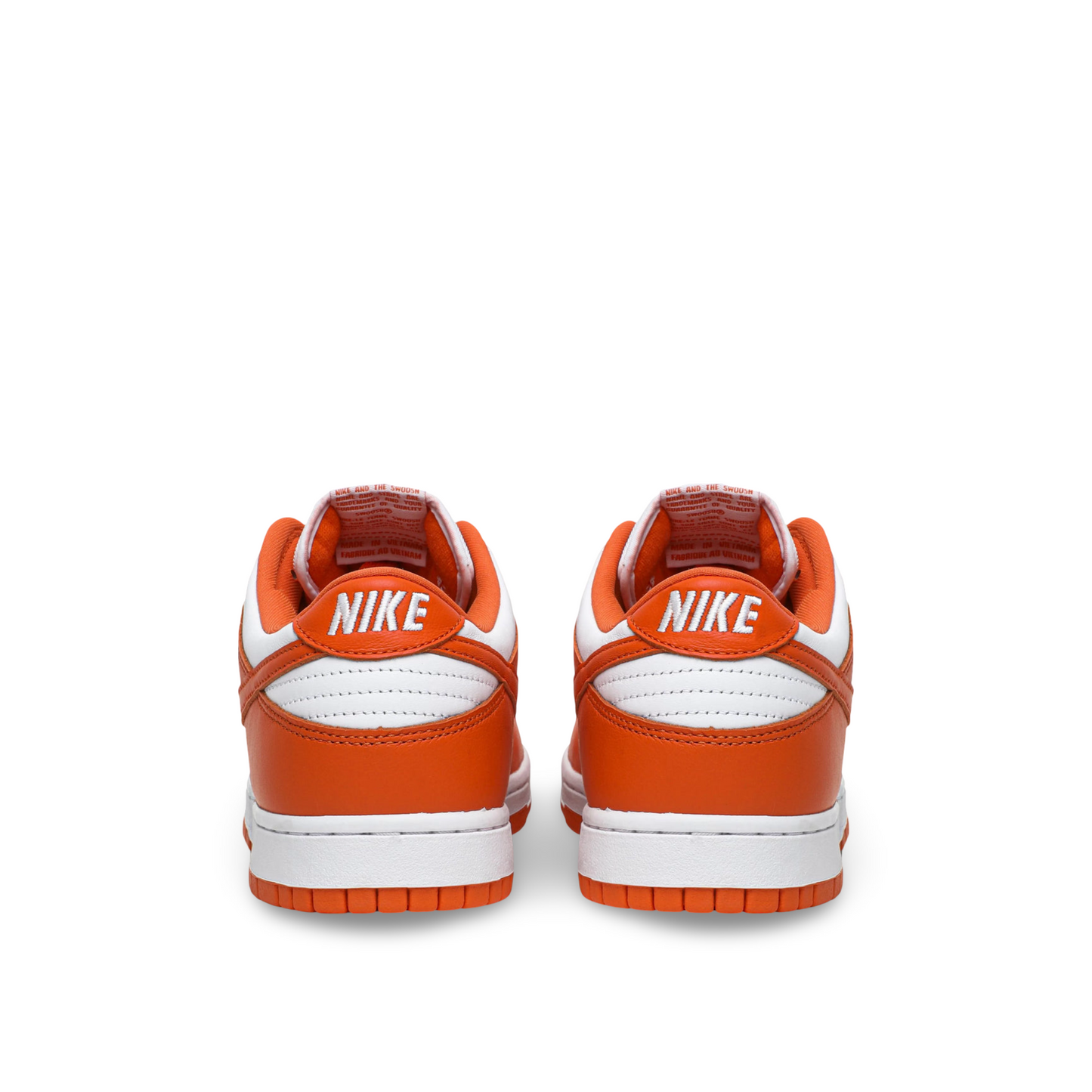 Back view of a pair of Nike sneakers with orange and white color scheme, featuring the Nike logo on the heel.