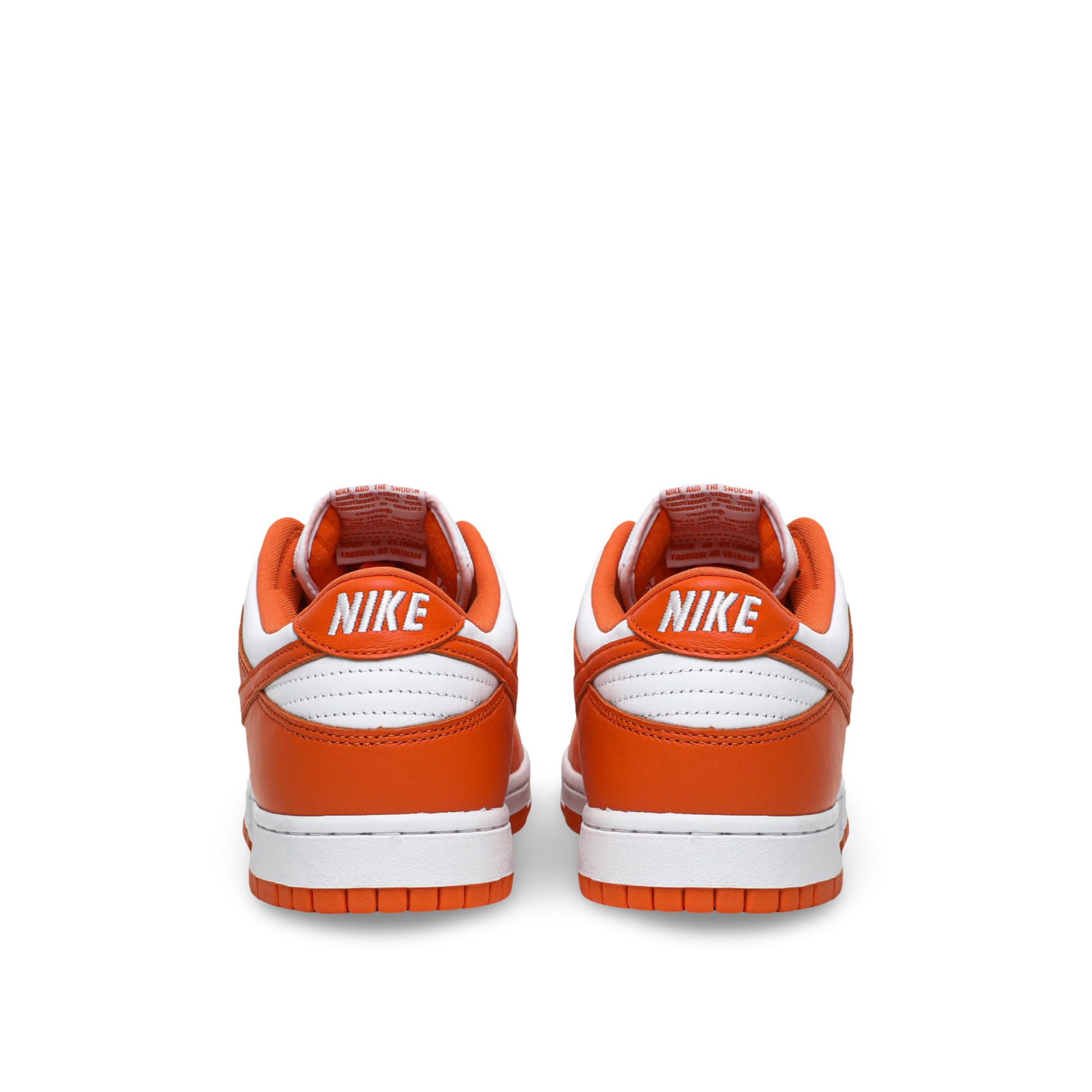 Back view of a pair of Nike sneakers with orange and white color scheme, featuring the Nike logo on the heel.